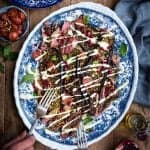 Griddled lamb with roasted aubergines, tomatoes and couscous - drizzle with yoghurt dressing and scatter with pistachios and pomegranate seeds