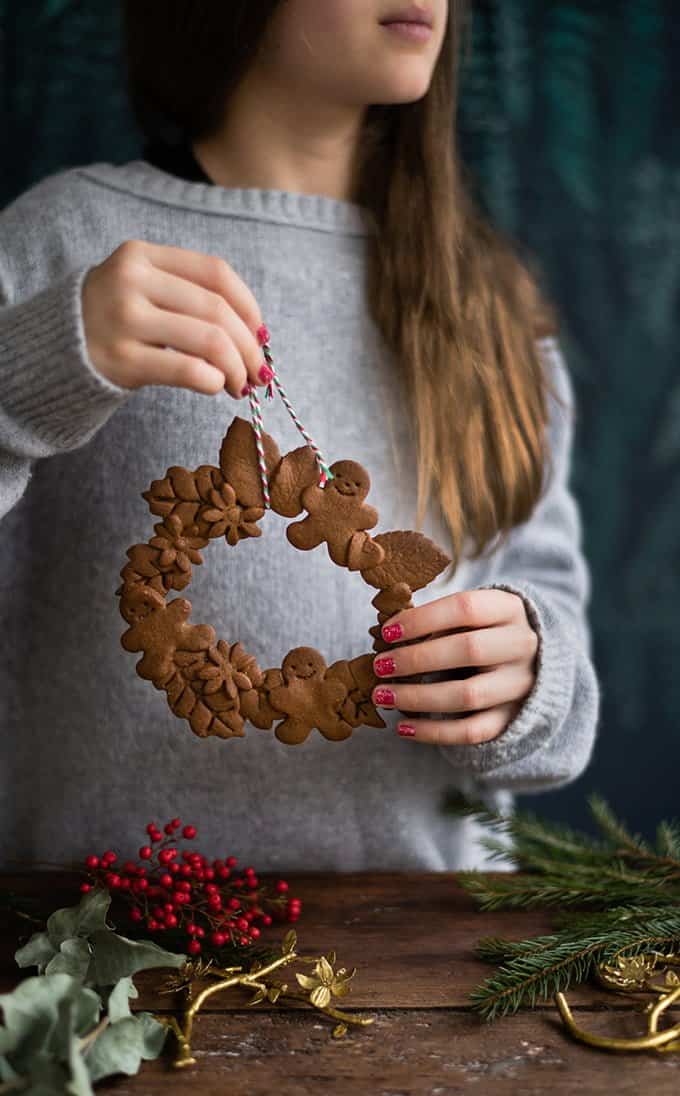 Girl holding a gingerbread cookie wreath