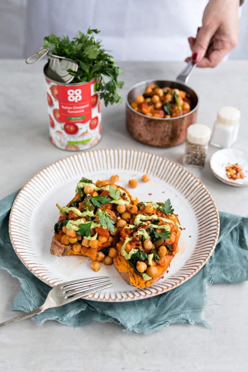 Baked sweet potatoes with spicy chickpeas and green tahini dressing - a vegan, gluten-free and totally satisfying quick meal that's ready in 30 minutes.