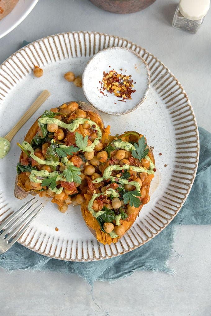 Baked sweet potatoes with spicy chickpeas and green tahini dressing - a vegan, gluten-free and totally satisfying quick meal