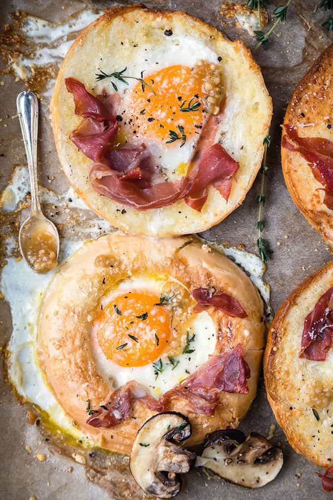 Sheet-pan baked eggs-in-a-hole with prosciutto and truffle pesto - delicious for breakfast, brunch or light lunch.