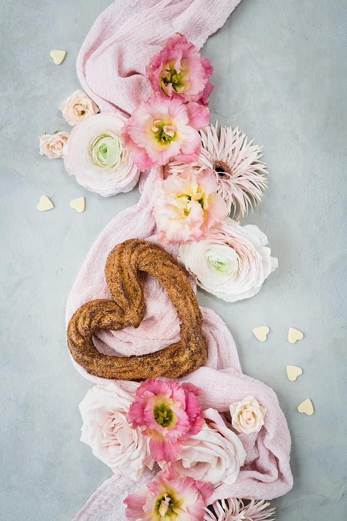 Heart-shaped churro arranged with fresh flowers