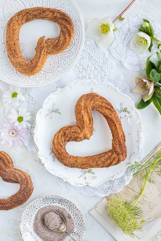 Heart-shaped vegan churros on pretty vintage plates 
