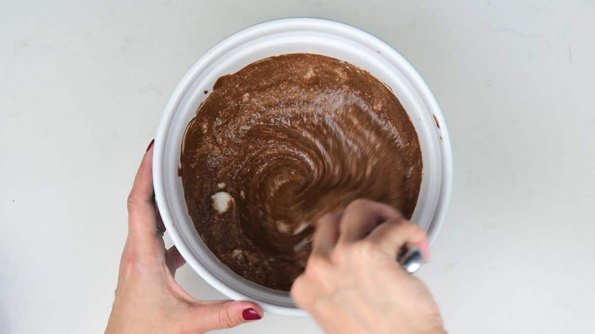 Folding in whisked egg whites to chocolate mousse