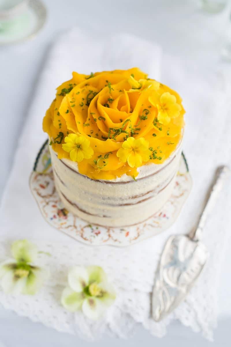 Vegan layer cake decorated with a fresh mango rose