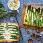 Two puff pastry tarts topped with asparagus