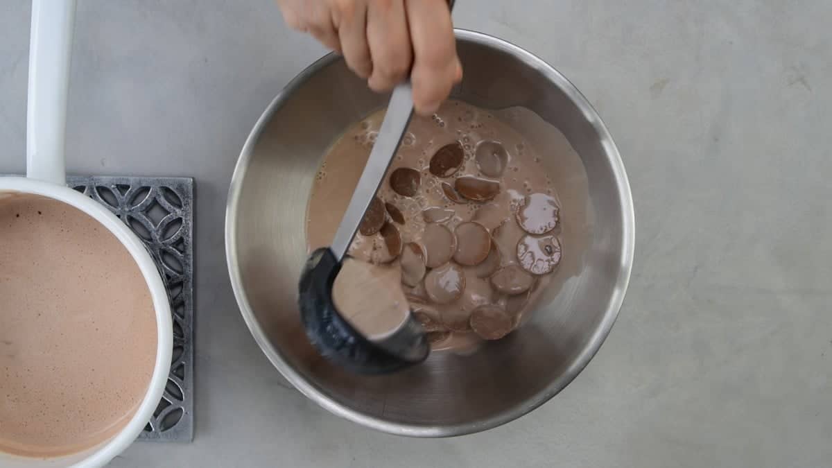 Adding hot milk to chocolate chips