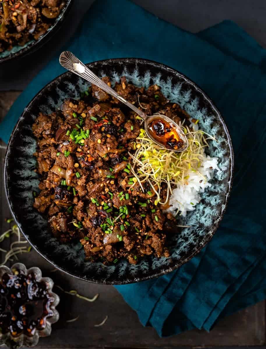 spicy beef mince stir fry with eggplant and mushrooms in a bowl with sticky rice