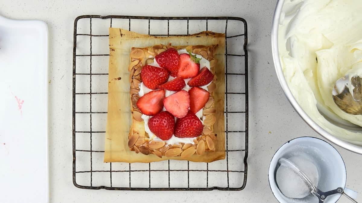 Topping puff pastry tarts with fresh strawberries