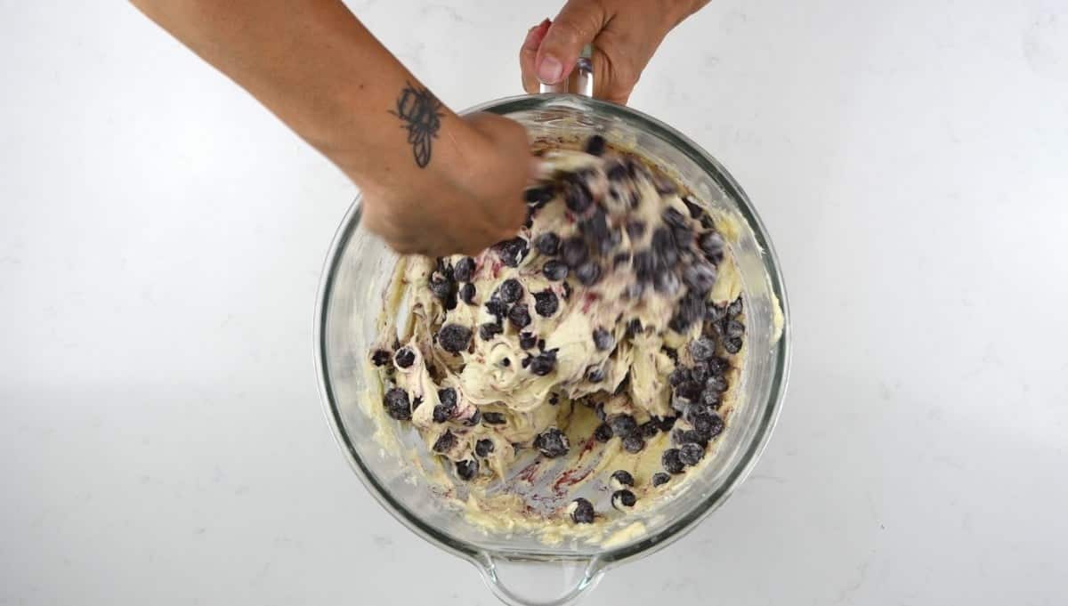 Fold blueberries into the cake batter