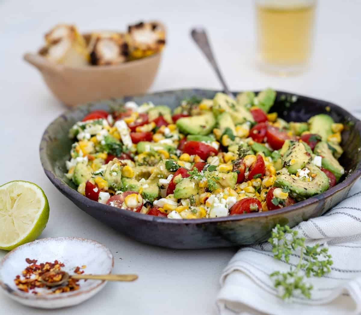 Grilled corn and avocado salad in a bowl