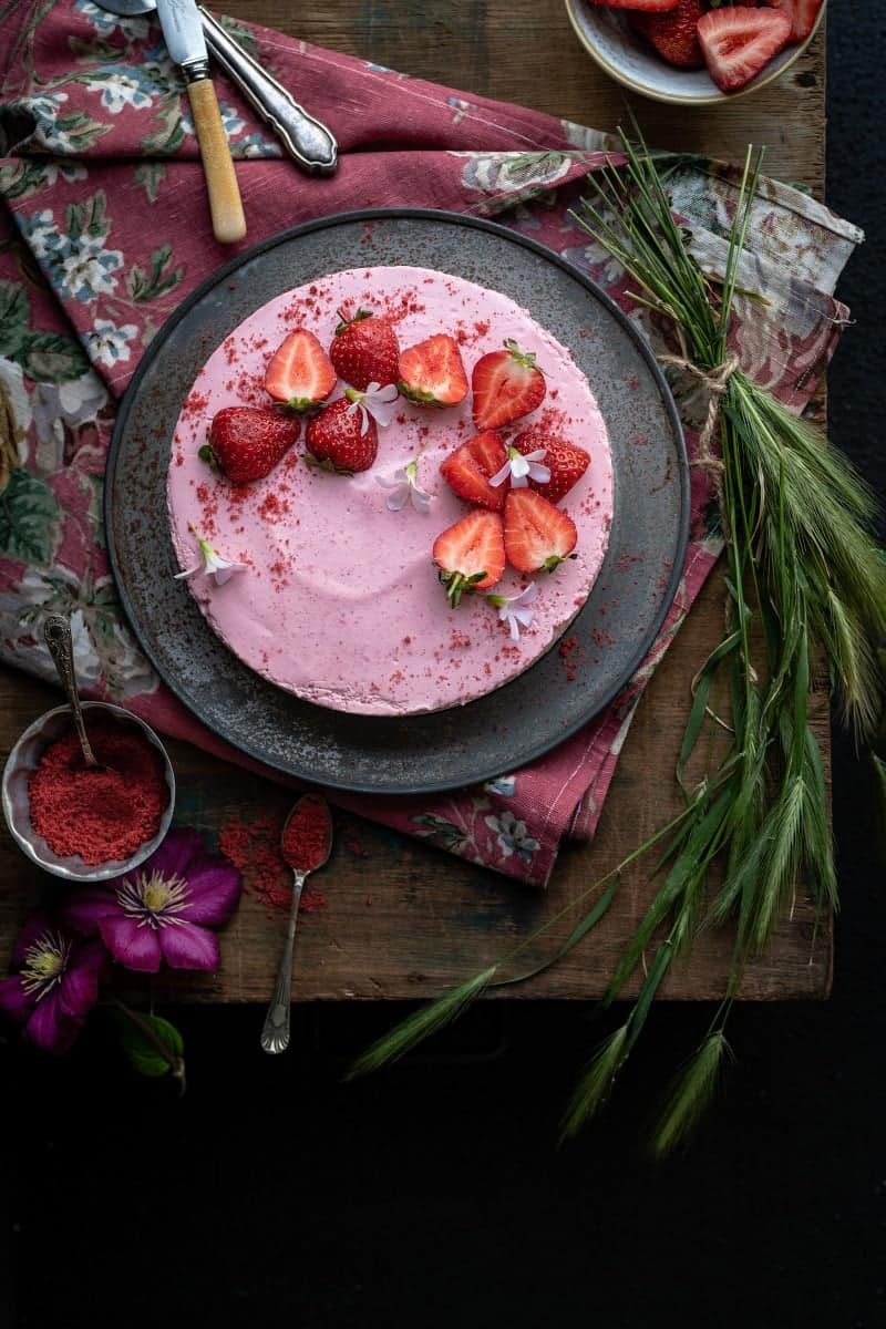 no-bake strawberry cheesecake decorated with fresh strawberries shown overhead
