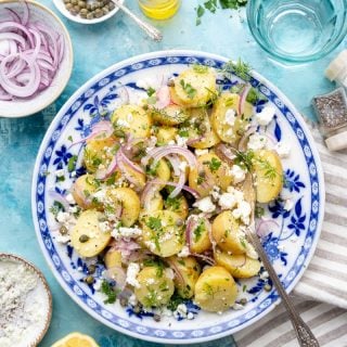 Greek Potato Salad on a blue patterned plate