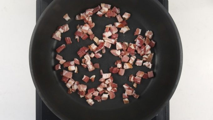 Frying smoked bacon lardons in a pan