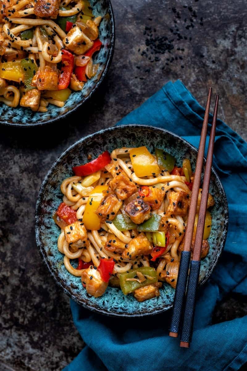 Bowl of stir fried tofu and peppers in tomato & garlic sauce