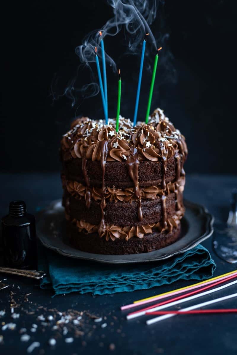 Candles blown out on chocolate birthday layer cake