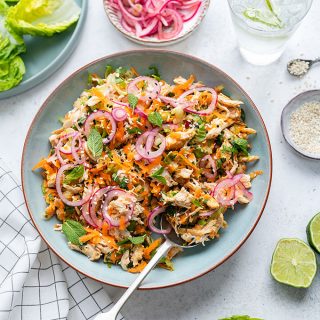 Overhead shot of healthy satay chicken salad with pickled onions