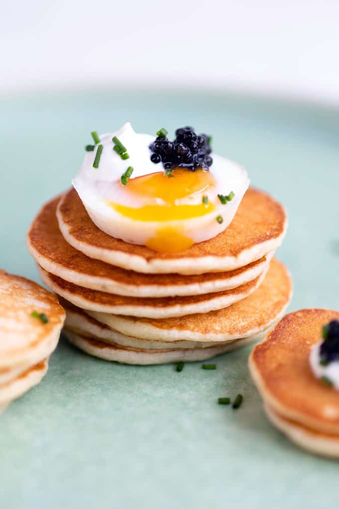 Stack of blini with egg and caviar