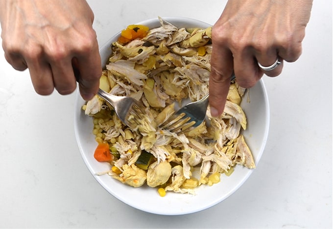 shredding cooked chicken using two forks