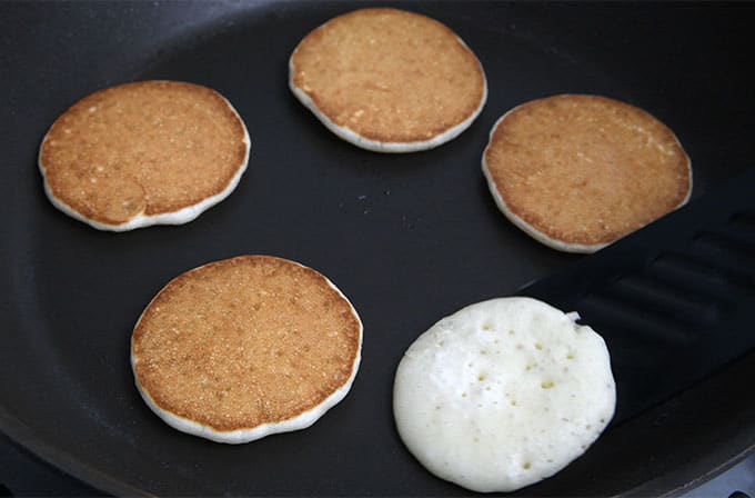 Frying mini pancakes in a skillet