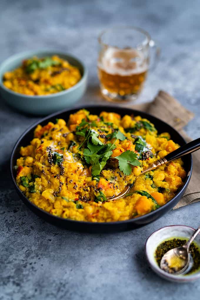 Vegan dhal curry with red lentils, squash, chickpeas and spinach 