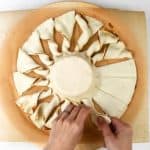 making puff pastry tart with pesto and brie
