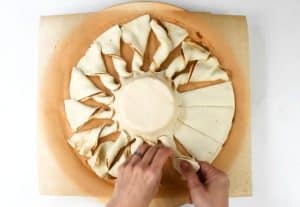making puff pastry tart with pesto and brie