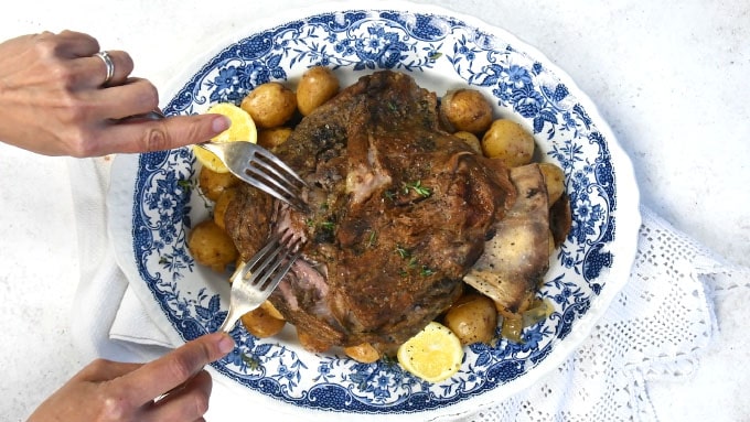Greek slow cooked lamb on a blue platter