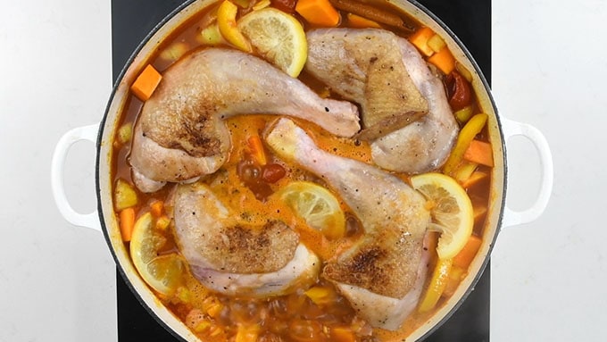 Close up of moroccan chicken casserole with lemon slices and squash