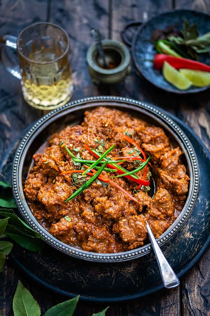 Large bowl of bhuna gosht curry on a dark background