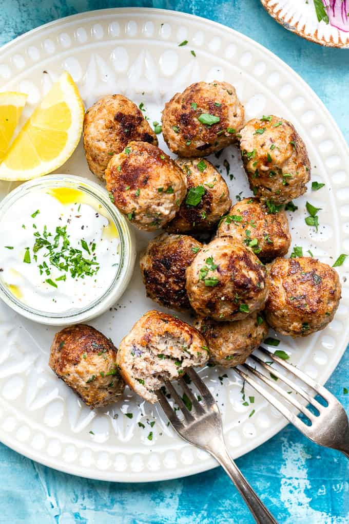 Close up on a plate of Greek meatballs (keftedes) served and Tzatziki