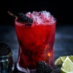 Blackberry Caipiroska in a rocks glass with crushed ice garnished by blackberries
