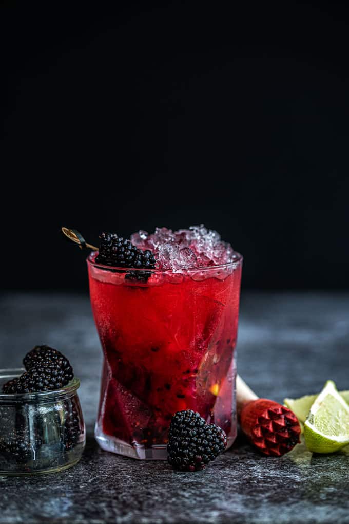 Glass of Blackberry Caipiroska against a dark background