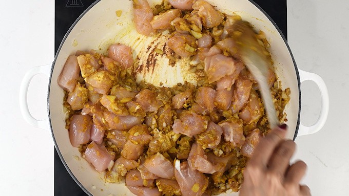 Frying chicken in Indian spices for Korma curry