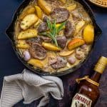Skillet of pan fried pork tenderloin with apples in a creamy sauce