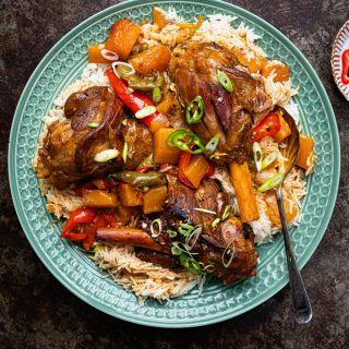Platter with coconut rice and braised lamb shanks with peppers and squash