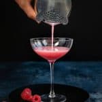 Straining a French Martini into a cocktail glass