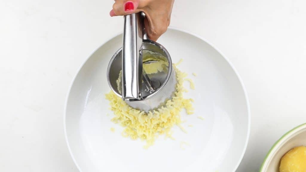 Using a potato ricer to make smooth mashed potatoes