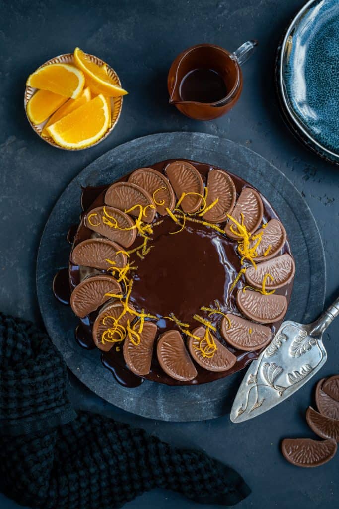 Chocolate Orange Cake covered in chocolate glaze and decorated with Terry's Chocolate Orange segments