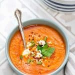 Bowl of homemade Tomato soup garnished with seeds and feta cheese