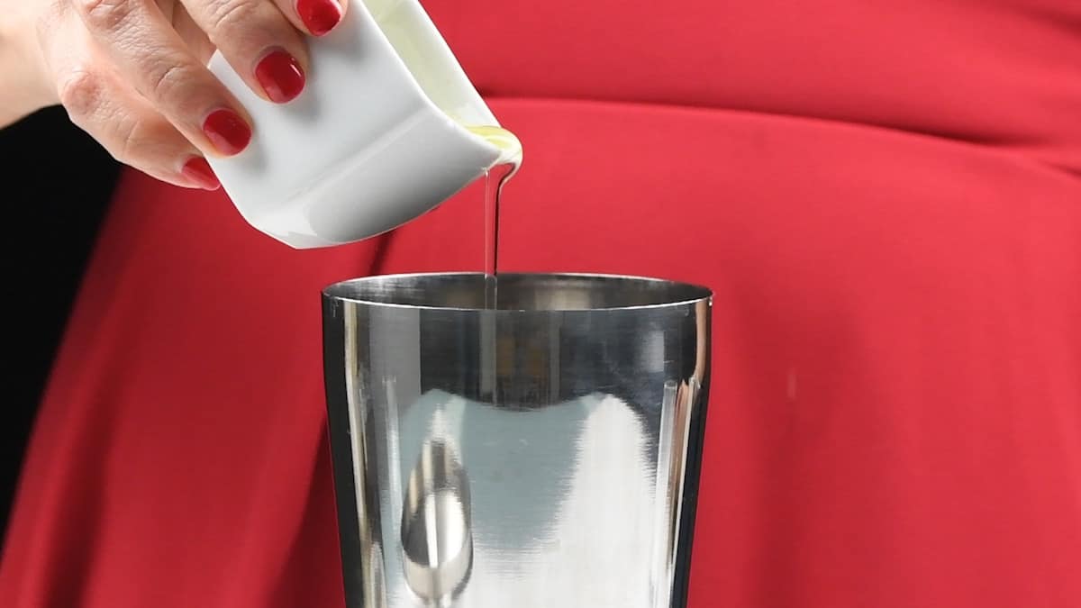 Adding egg white to a cocktail shaker