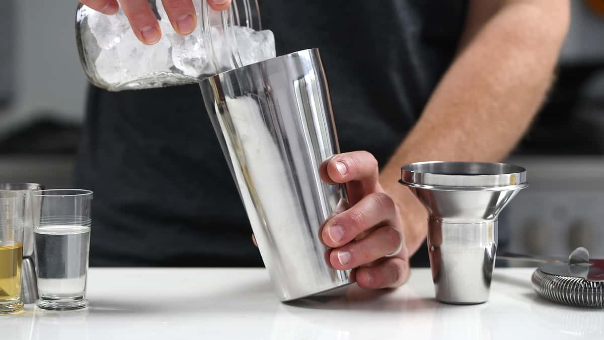 Adding ice to cocktail shaker