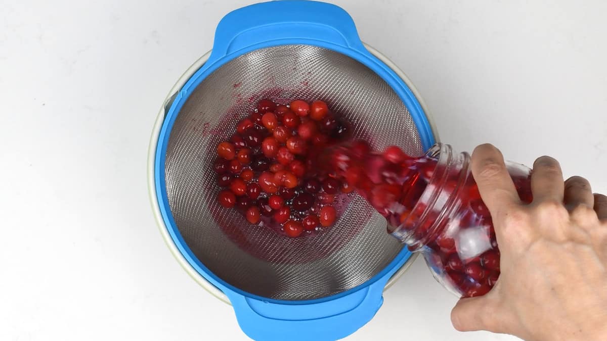 Straining cranberry infused vodka