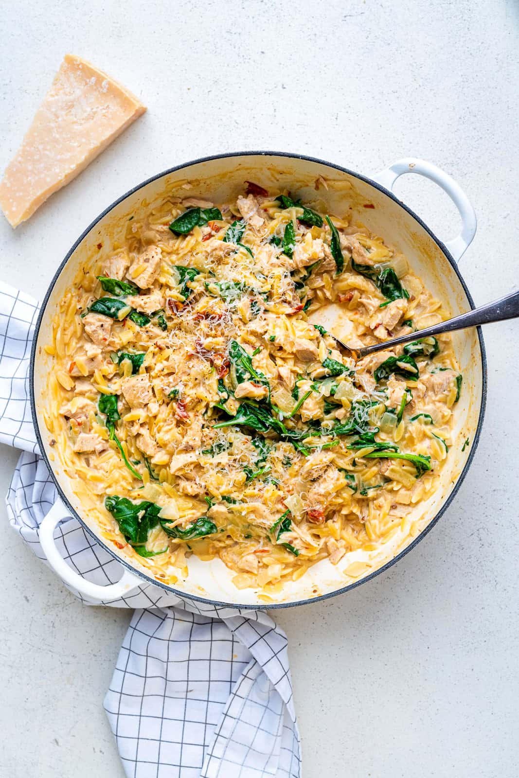 Casserole dish of creamy Tuscan orzo pasta with leftover turkey