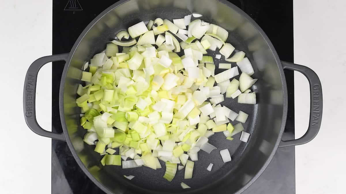 cooking onions and leeks in a pot