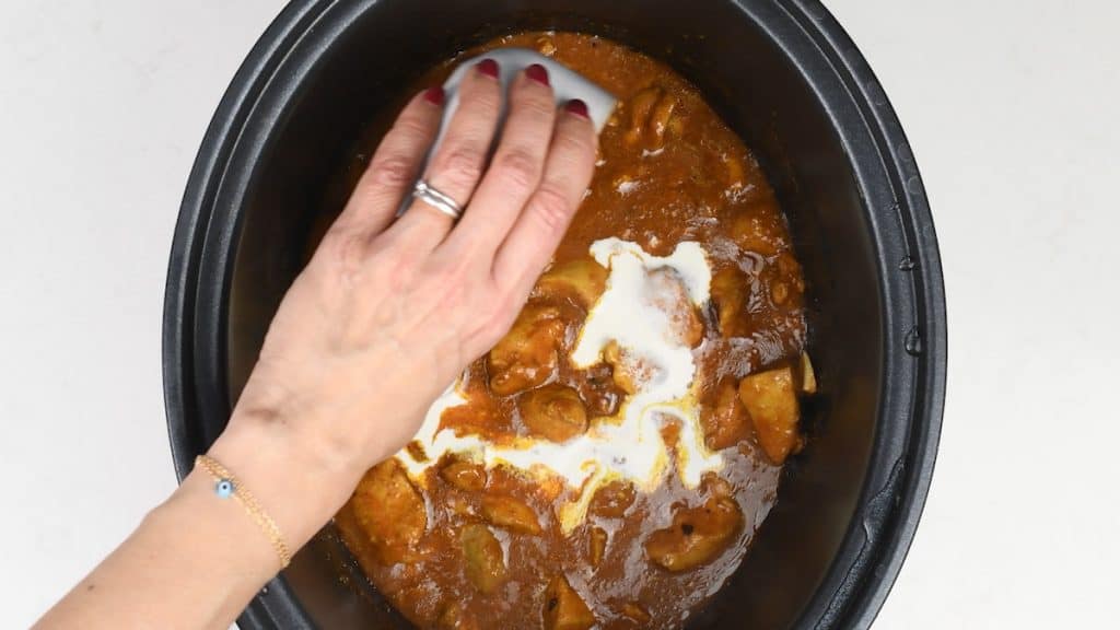 stirring cream into chicken curry