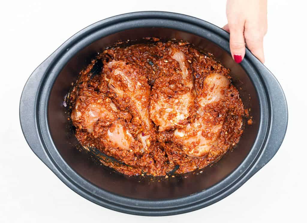 Chicken breast covered in spicy paste in slow cooker