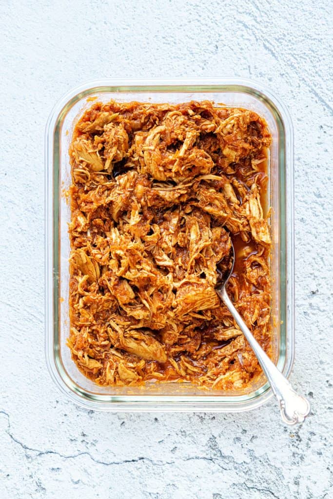 Bowl of pulled chicken in tangy sauce
