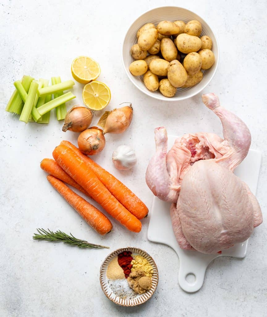 Ingredients for slow cooker roast chicken on a white background