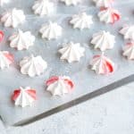 meringue cookies piped on a baking tray